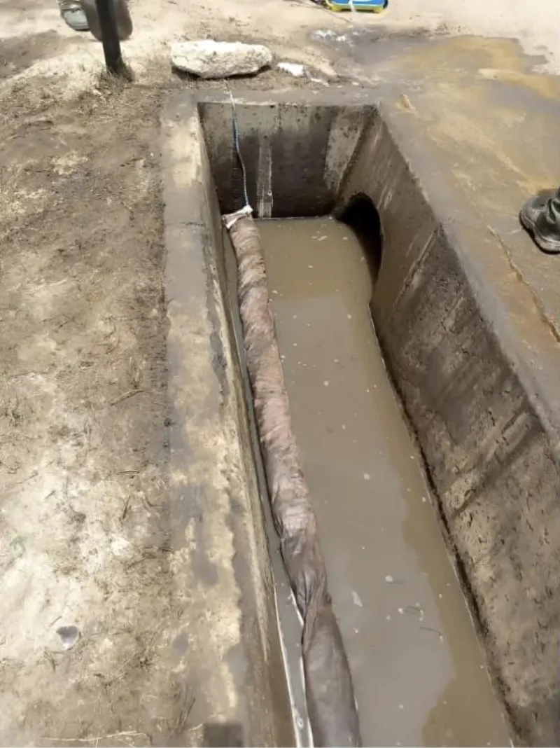 Spill containment in a drainage channel on a civil works project
